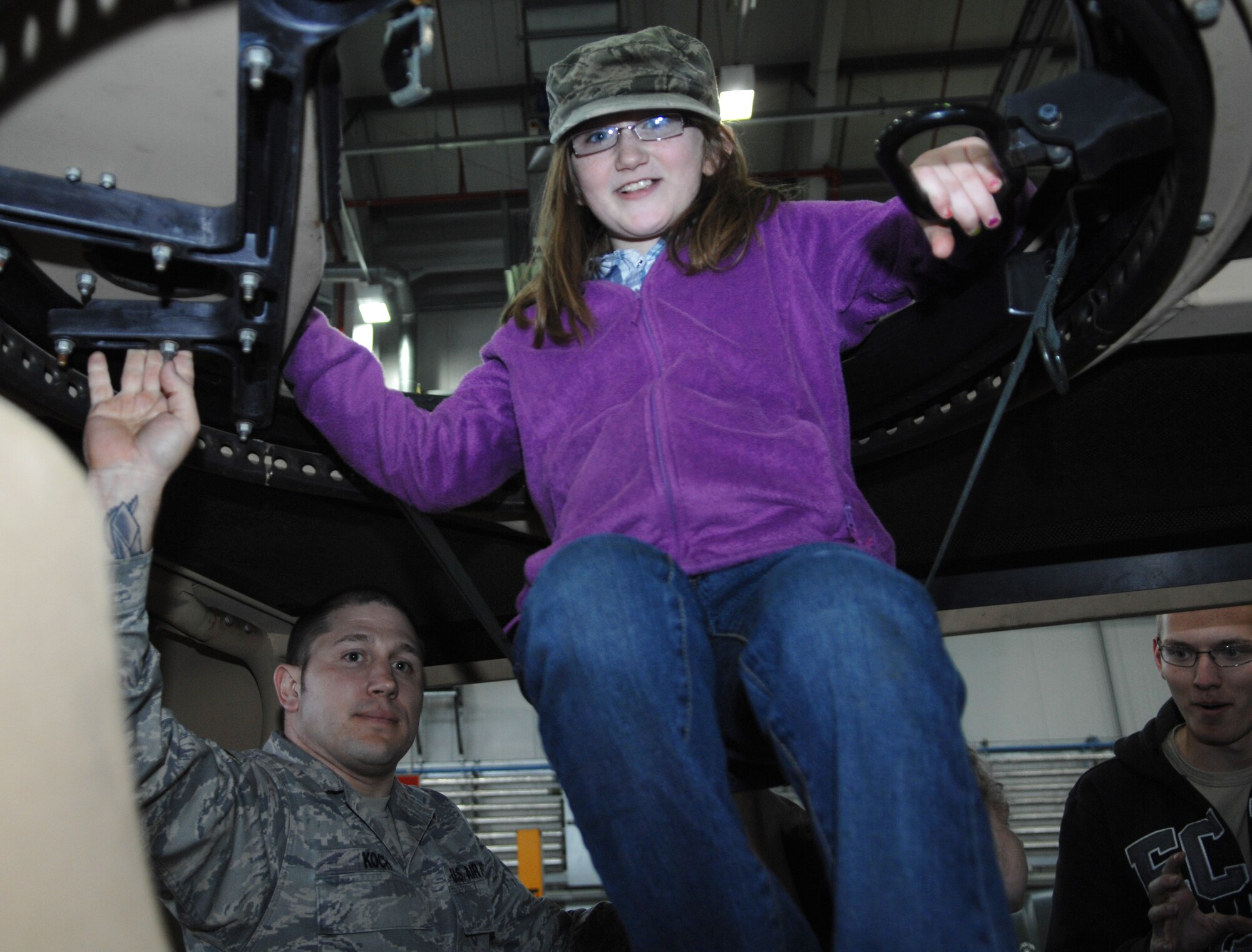 Kiarra Richardson, 9, daughter of Senior Master Sgt. Orin Richardson, 100th Security Forces Squadron operations superintendent, sits in the turret seat of a Humvee during Job Shadow Day April 19, 2013, on RAF Mildenhall, England. Job Shadow Day participants got the chance to view static displays of equipment used by various shops around base. The KC-135 Stratotanker, fire trucks and fuel trucks are only a few of the displays around base. (U.S. Air Force photo by Airman 1st Class Dillon Johnston/Released)