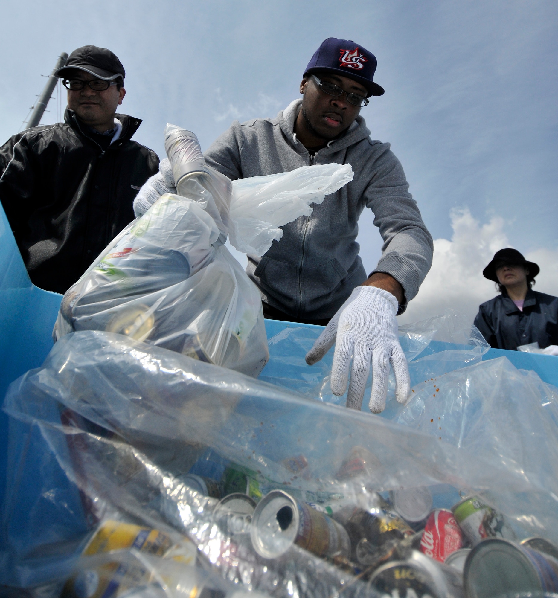 Najee Crawford, 35th Medical Group manpower specialist, places a bag of cans into a collection bin at the 15th Annual Misawa Port Cleanup, April 20, 2013. Volunteers fanned out across the port’s docks, parking lots and walkways picking up trash. (U.S. Air Force photo by Tech. Sgt. Phillip Butterfield)