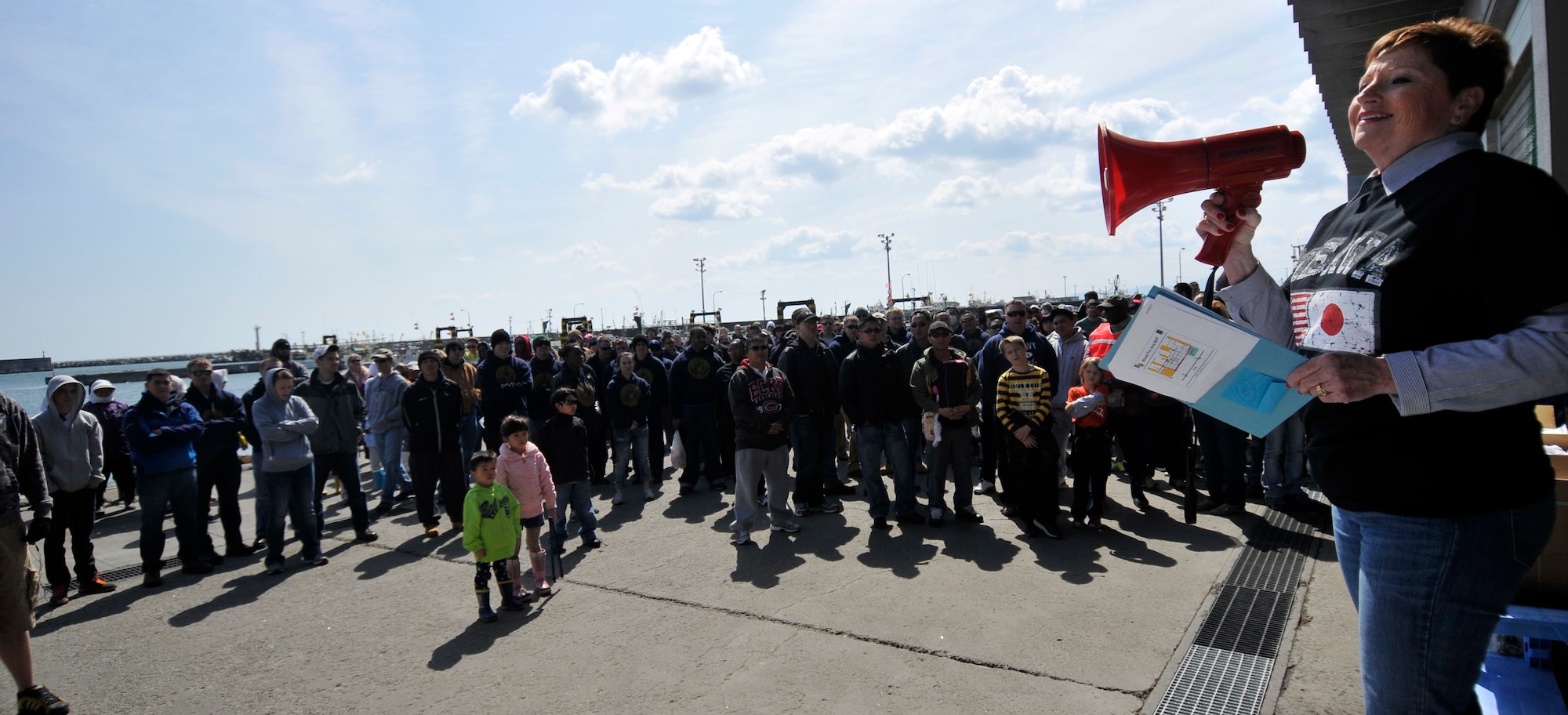 Donna Dahlstrom, 35th Civil Engineer Squadron asset management chief, thanks volunteers for their help at the 15th Annual Misawa Port Cleanup, April 20, 2013. More than 500 volunteers arrived to help remove garbage from the port. (U.S. Air Force photo by Tech. Sgt. Phillip Butterfield)