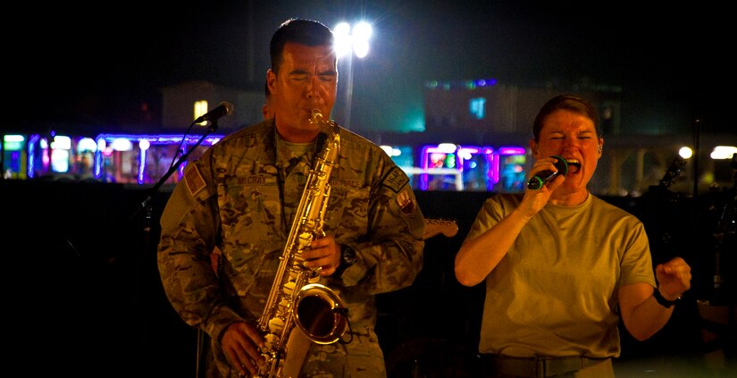 U.S. Air Force Master Sgt. Jake McCray, Air Force Central Command Band “Vector” saxophonist, and Tech. Sgt. Paige Martin, vocalist, perform on The Boardwalk at Kandahar Airfield, Afghanistan, April 16, 2013. (U.S. Air Force photo/Senior Airman Scott Saldukas)