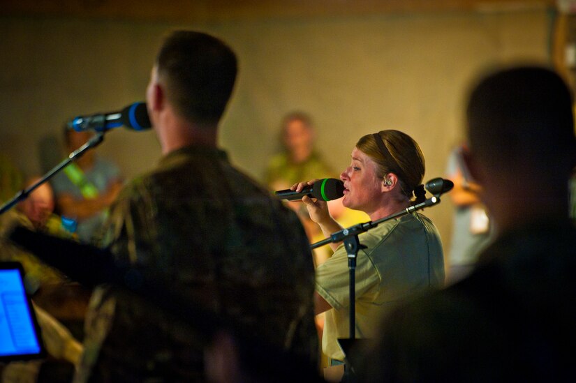 Tech. Sgt. Paige Martin, Air Force Central Command Band “Vector” vocalist, performs on The Boardwalk at Kandahar Airfield, Afghanistan, April 16, 2013. (U.S. Air Force photo/Senior Airman Scott Saldukas)