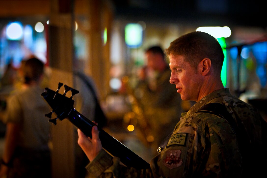 Senior Master Sgt. Mitchell Morton, Air Force Central Command Band “Vector” bass player, performs on The Boardwalk at Kandahar Airfield, Afghanistan, April 16, 2013. (U.S. Air Force photo/Senior Airman Scott Saldukas)