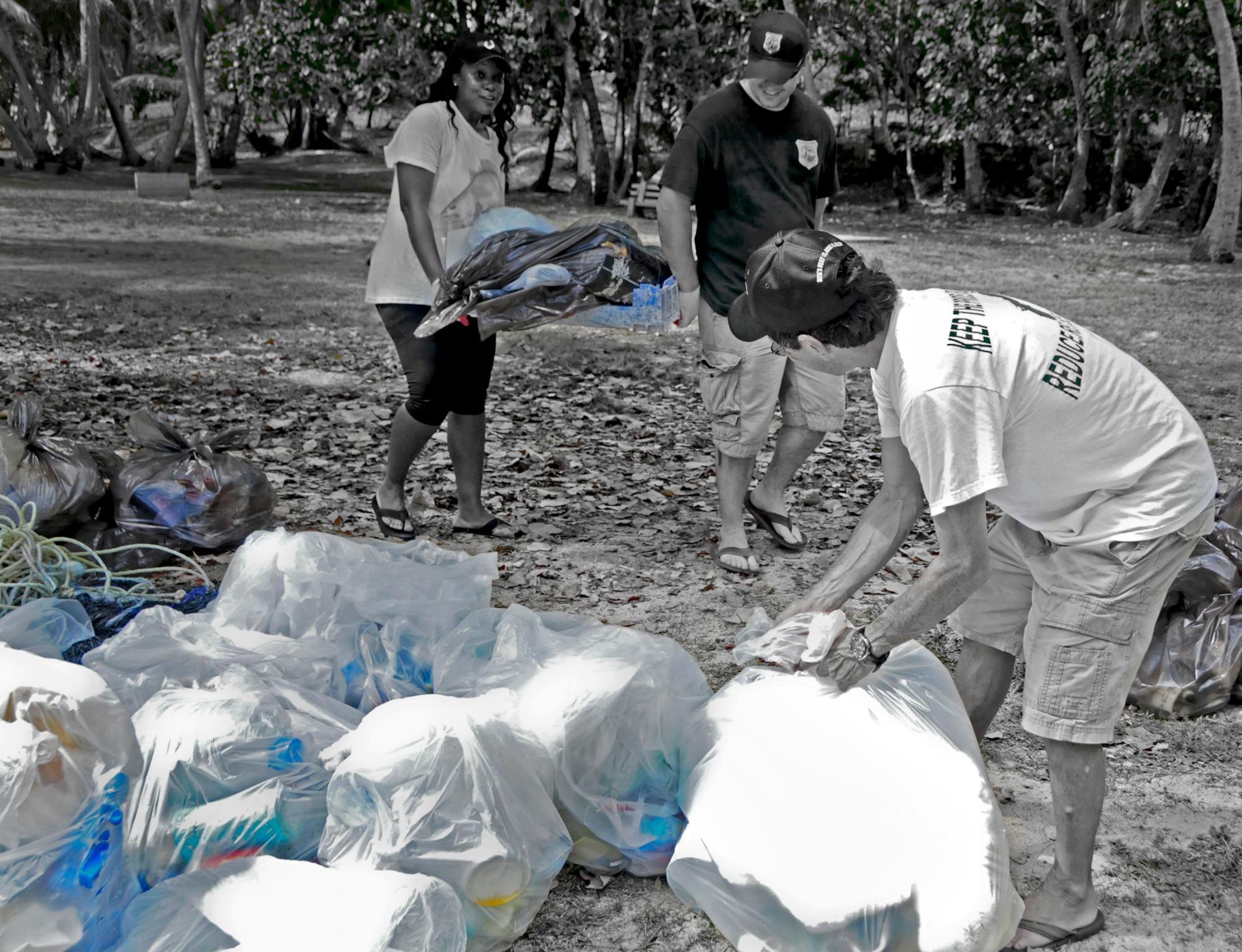 Volunteers collect and sort out recyclable material during the Earth Day cleanup on Tarague Beach at Andersen Air Force Base, Guam, April 21, 2013. Along with collecting trash, volunteers tracked the amount and brands of the waste they collected, which was sent to the U.S. Environmental Protection Agency Regions 9 for their study on sources of rubbish in oceans. (U.S. Air Force photo illustration by Airman 1st Class Marianique Santos/Released)
