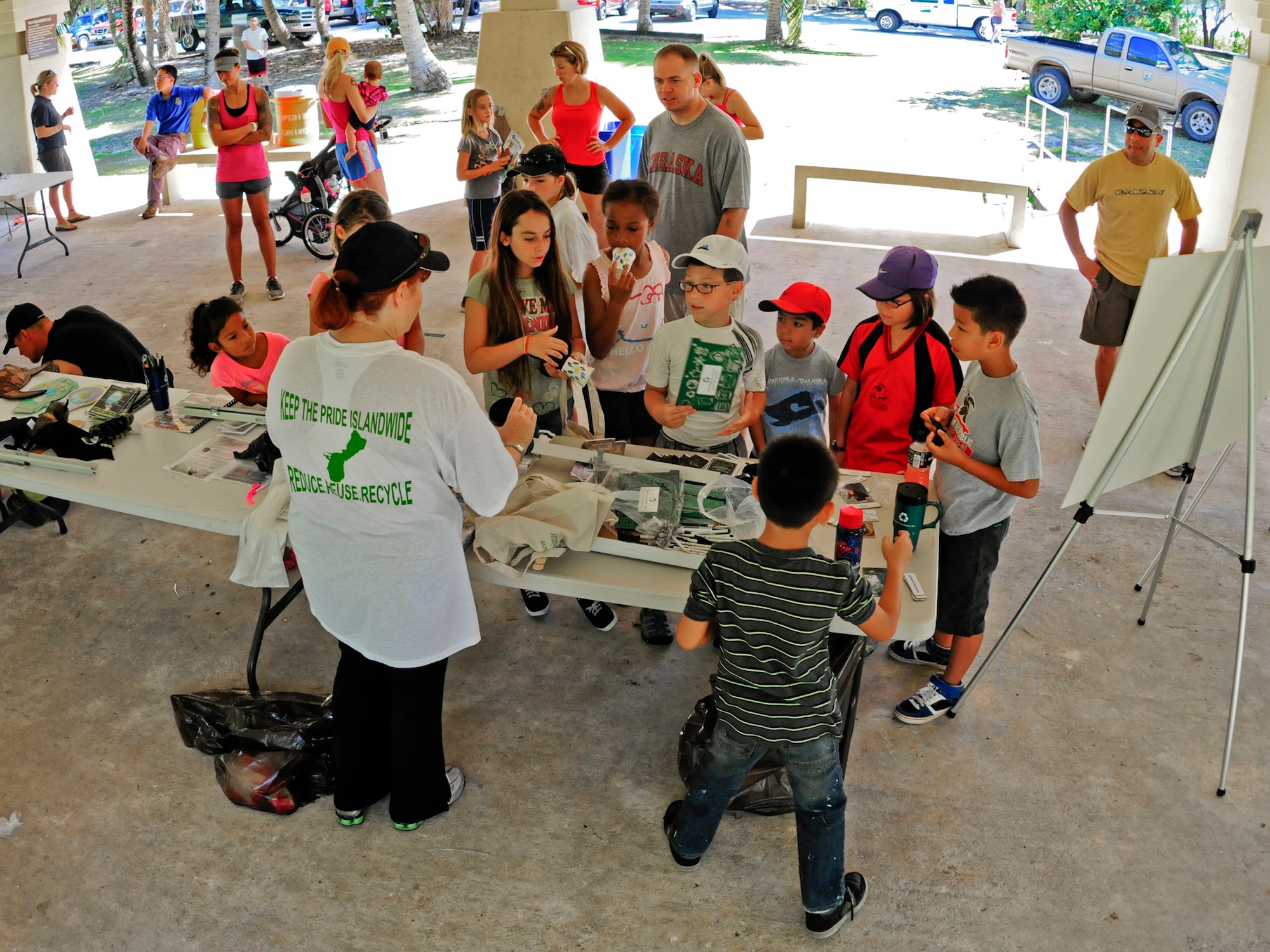 Young volunteers play games that promote environmental conservation during the Earth Day event at Andersen Air Force Base, Guam, April 21, 2013. In celebration of Earth Day, the 36th Civil Engineer Squadron environmental flight facilitated a beach cleanup, displayed natural, cultural and historical exhibits, offered educational games and gave out prizes to promote environmental awareness. (U.S. Air Force photo by Airman 1st Class Marianique Santos/Released)