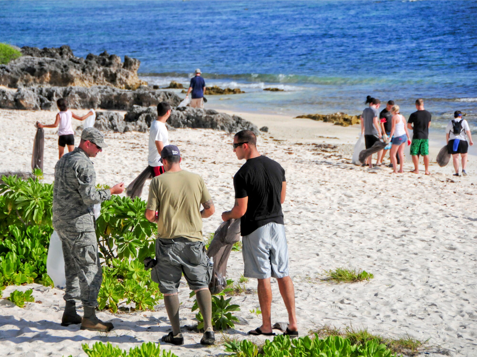 Volunteers consolidate into small groups to keep track of the amount and type of trash they collect during the Earth Day cleanup on Tarague Beach at Andersen Air Force Base, Guam, April 21, 2013. Along with collecting trash, volunteers tracked the amount and brands of the waste they collected, which was sent to the U.S. Environmental Protection Agency Regions 9 for their study on sources of rubbish in oceans. (U.S. Air Force photo by Airman 1st Class Marianique Santos/Released)