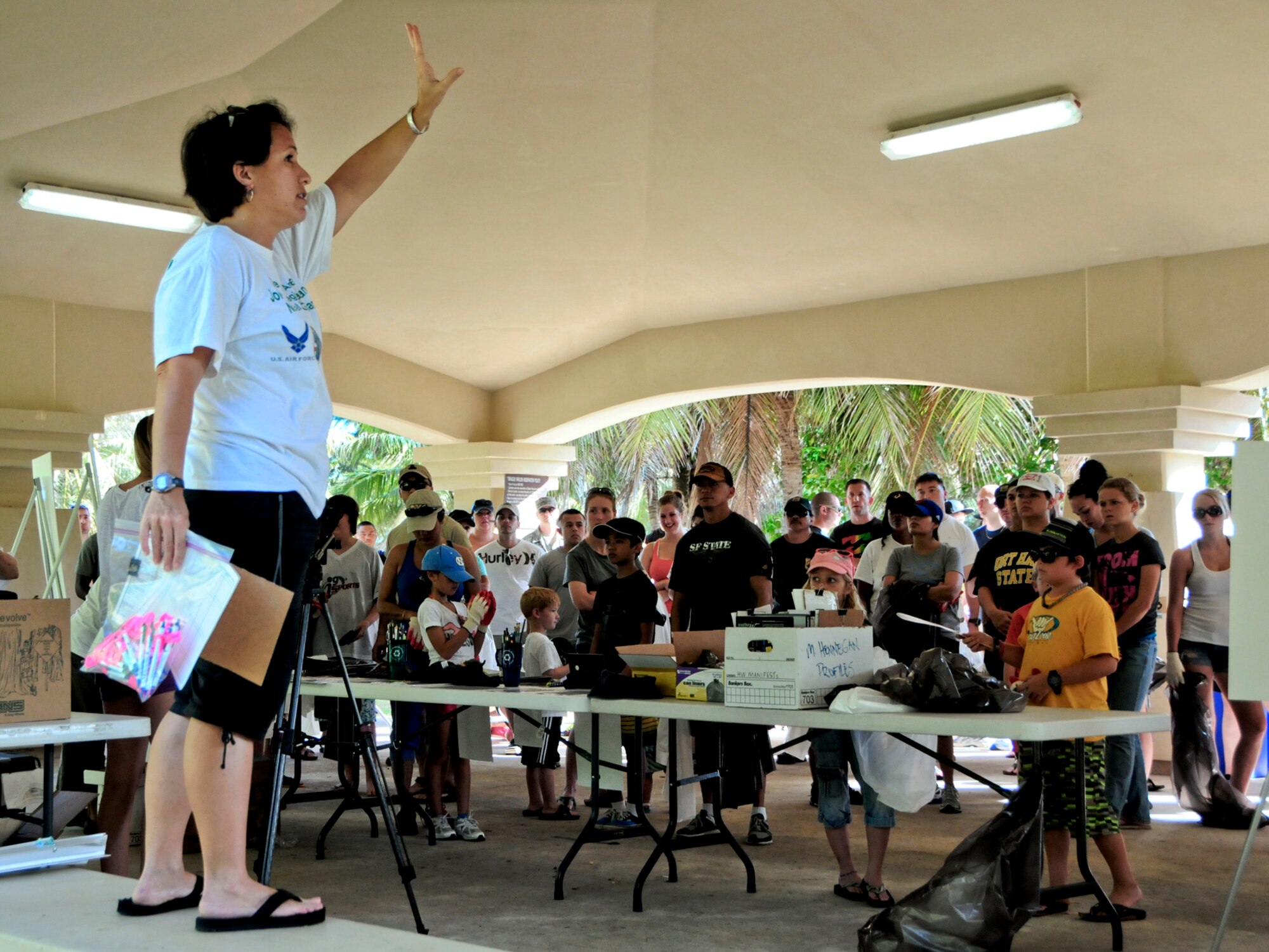 Leanne Obra, 36th Civil Engineer Squadron environmental flight natural resource specialist, welcomes volunteers to the Earth Day cleanup on Tarague Beach at Andersen Air Force Base, Guam, April 21, 2013. Along with collecting trash, volunteers tracked the amount and brands of the waste they collected, which was sent to the U.S. Environmental Protection Agency Regions 9 for their study on sources of rubbish in oceans. (U.S. Air Force photo by Airman 1st Class Marianique Santos/Released)