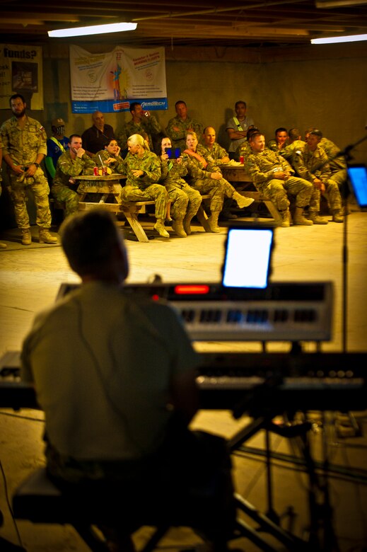 U.S. and Coalition servicemember’s cheer for the Air Force Central Command Band “Vector” as they perform on The Boardwalk at Kandahar Airfield, Afghanistan, April 16, 2013. (U.S. Air Force photo/Senior Airman Scott Saldukas)