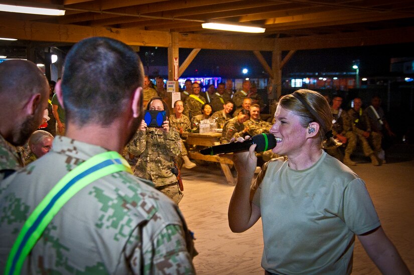 Tech. Sgt. Paige Martin, Air Force Central Command Band “Vector” vocalist, performs on The Boardwalk at Kandahar Airfield, Afghanistan, April 16, 2013. (U.S. Air Force photo/Senior Airman Scott Saldukas)