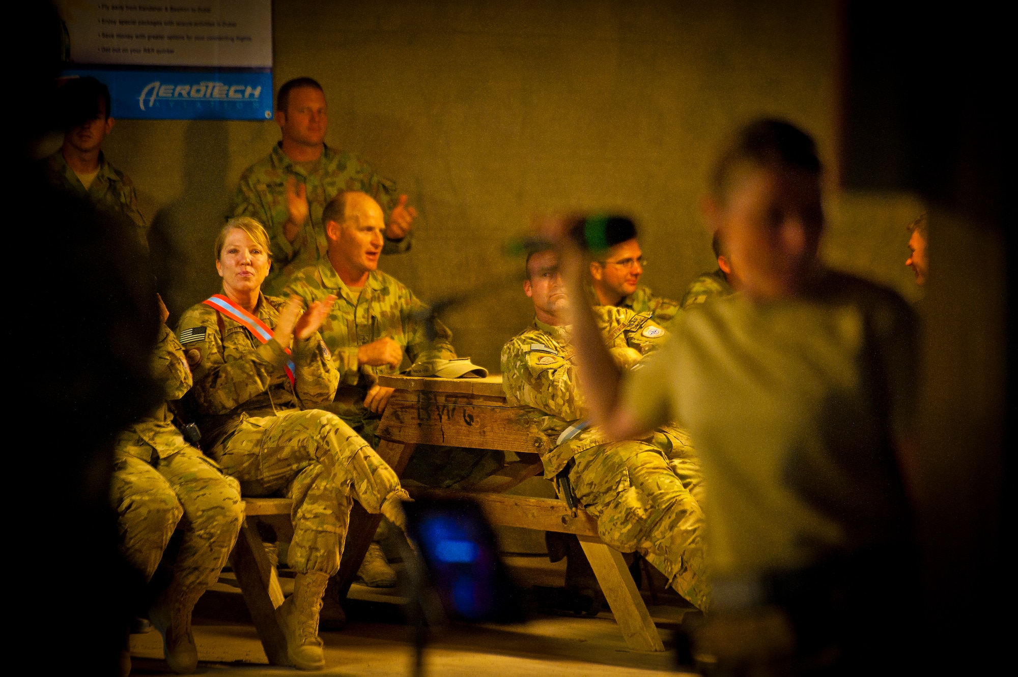 U.S. and Coalition servicemember’s cheer for the Air Force Central Command Band “Vector” as they perform on The Boardwalk at Kandahar Airfield, Afghanistan, April 16, 2013. (U.S. Air Force photo/Senior Airman Scott Saldukas)