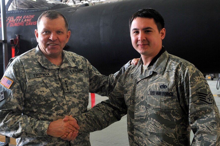 Gen. James D. Thurman, commander of the United Nations Command, the Combined Forces Command and U.S. Forces Korea, coins Staff Sgt. Brett Lane, 5th Reconnaissance Squadron Dedicated Crew Chief, April 19, 2013, Osan Air Base, Republic of Korea. Staff Sgt. Lane was selected for his superior performance and dedication to the mission. (U.S. Air Force photo/Tech. Sgt. Raymond Mills) 