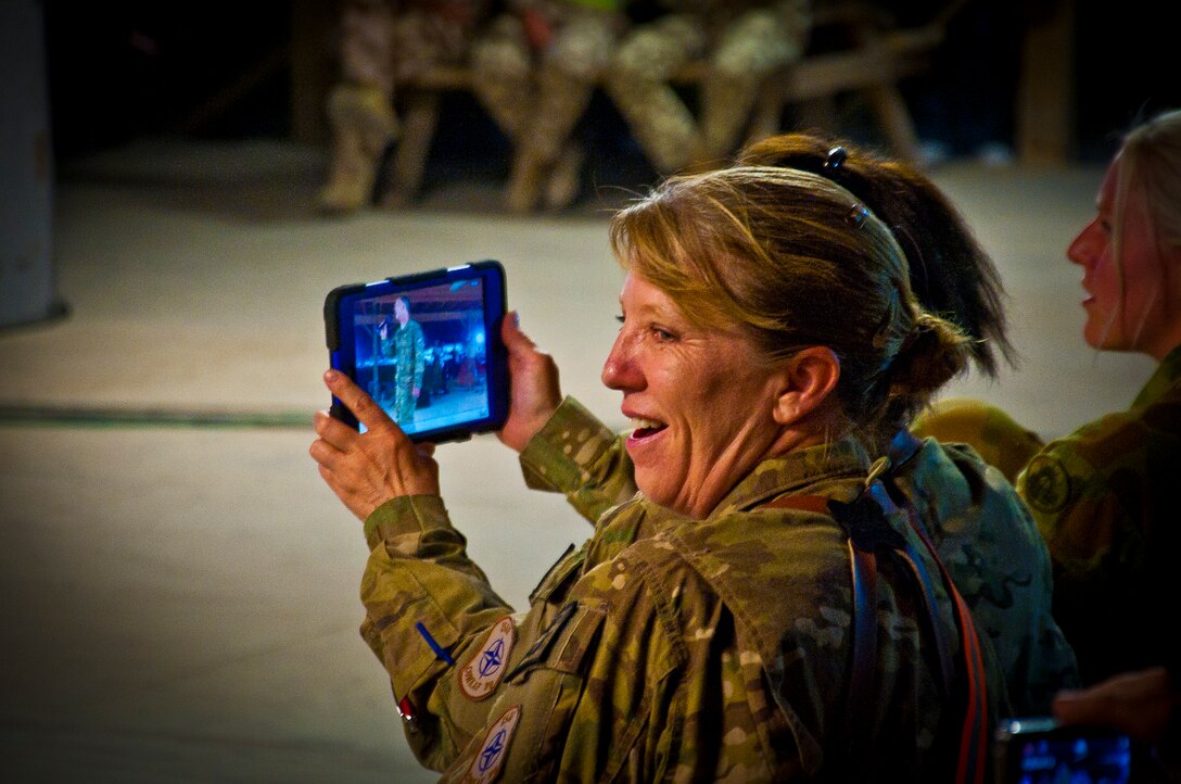 U.S. and Coalition servicemember’s cheer for the Air Force Central Command Band “Vector” as they perform on The Boardwalk at Kandahar Airfield, Afghanistan, April 16, 2013. (U.S. Air Force photo/Senior Airman Scott Saldukas)