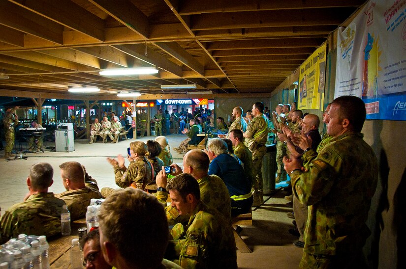 U.S. and Coalition servicemember’s cheer for the Air Force Central Command Band “Vector” as they perform on The Boardwalk at Kandahar Airfield, Afghanistan, April 16, 2013. (U.S. Air Force photo/Senior Airman Scott Saldukas)