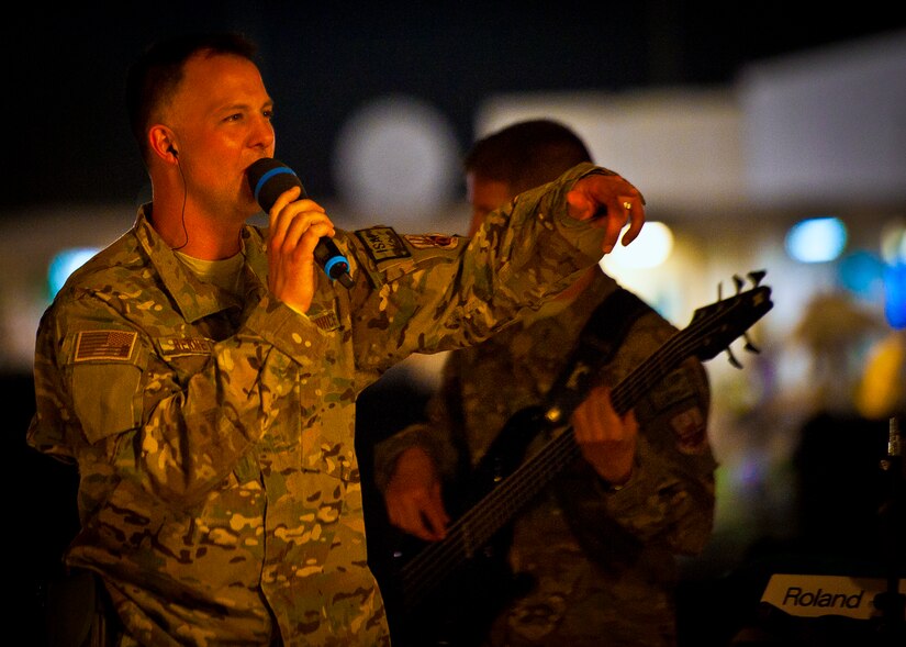 U.S. Air Force Master Sgt. Bradley Bennett, Air Force Central Command Band “Vector” vocalist, performs on The Boardwalk at Kandahar Airfield, Afghanistan, April 16, 2013. (U.S. Air Force photo/Senior Airman Scott Saldukas)