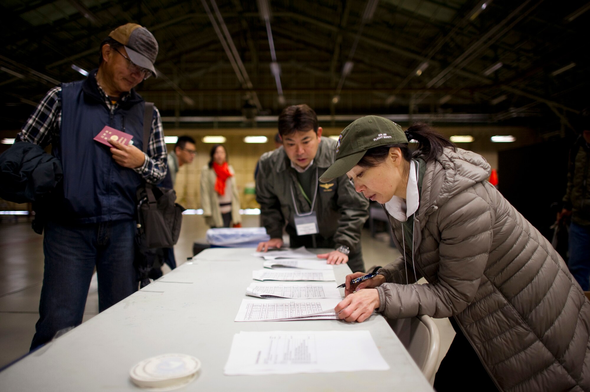 YOKOTA AIR BASE, Japan – Haru Kato, Mid-Air Collision Avoidance Fly-in Conference volunteer, checks in local pilots prior to briefings at Yokota Air Base, Japan, April 21, 2013. The MACA conference is designed to give local pilots a better understanding of Yokota’s flight and approach control operations and leads to a safer flying environment across the Kanto Plain. (U.S. Air Force photo by Staff Sgt. Chad C. Strohmeyer/Released) 