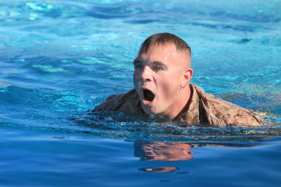 Marine Corps Sgt. Jeremy Teft participates in the 500-meter swim during ...