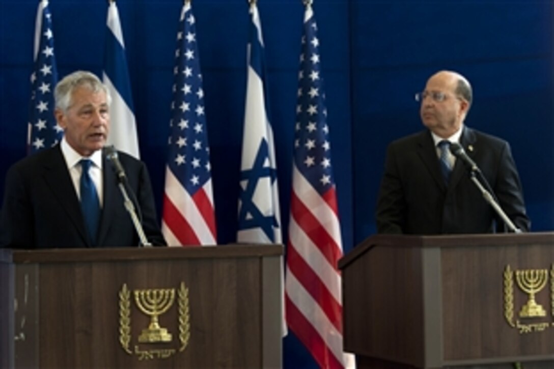 U.S. Defense Secretary Chuck Hagel, left, holds a joint press conference with Israeli Defense Minister Moshe Yaalon in Tel Aviv, Israel, April 22, 2013. Hagel and Yaalon answered questions regarding Iran's attempts at producing a nuclear weapon as well as the civil war in Syria.