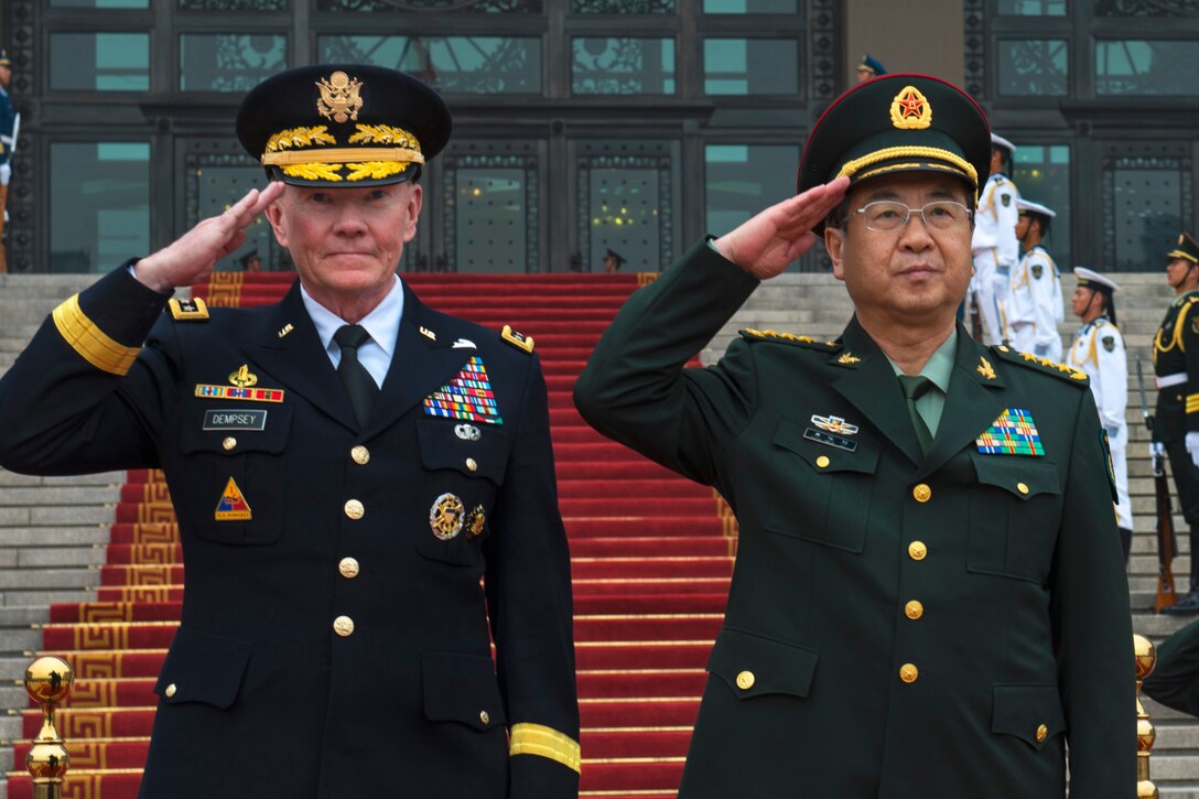 U.S. Army Gen. Martin E. Dempsey, left, chairman of the Joint Chiefs of Staff, salutes with Chinese Gen. Fang Fenghui, chief of the general staff, in Beijing, April 22, 2013.