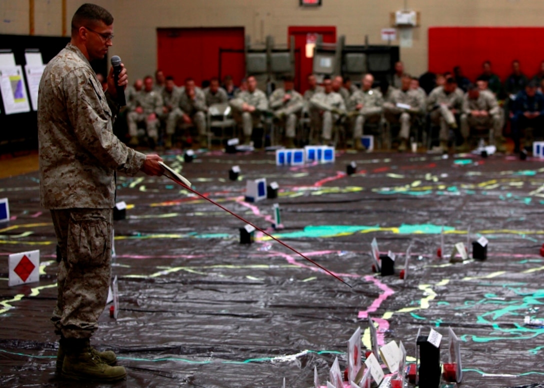 Lt. Col. Michael Reilly with the 2d Marine Expeditionary Brigade, briefs the lay down of enemy forces to Marines, Sailors and coalition partners at a rehearsal of concept drill during Bold Alligator 2013 at Camp Allen, Norfolk, Va., April 19. Bold Alligator 13 is a synthetic, scenario-driven exercise designed to train staffs primarily from 2d Marine Expeditionary Brigade and Expeditionary Strike Group 2 in an effort to continue revitalizing and improving their ability to integrate and execute large-scale operations from the sea. Thirty commands, to include seven ships (participating pier-side), and approximately 3,500 personnel from 16 countries and Strike Force NATO are planning to participate in the exercise.