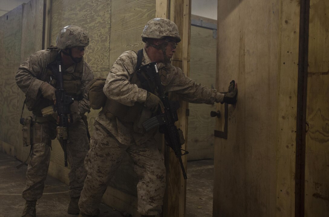 Company B, 2nd Reconnaissance Battalion Marines enter a room as they clear a training facility during live-fire training at Marine Corps Base Camp Lejeune, N.C., April 19, 2013. More than 120 Marines completed the two-week training, which included close-quarters tactics and flash bang procedures. (Marine Corps photo by Sgt. Austin Hazard/Released)