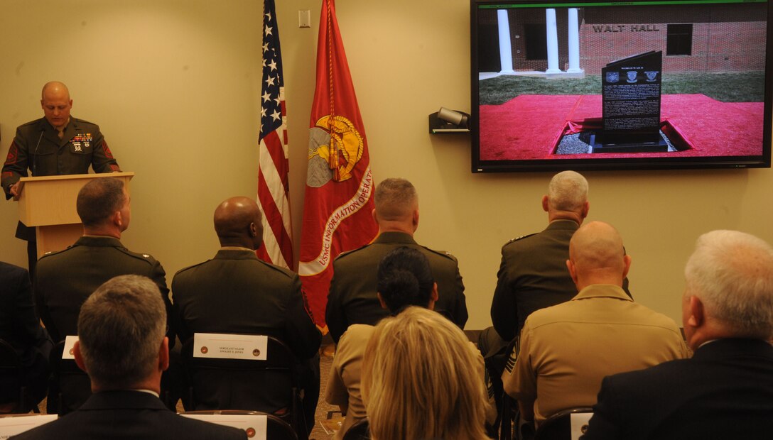 A monument highlighting some of Gen. Lewis Walt’s military accomplishments is presented on a screen during the dedication of Walt Hall on April 19, 2013. Walt Hall is the new building that houses the Marine Corps Information Operations Center on Marine Corps Base Quantico.