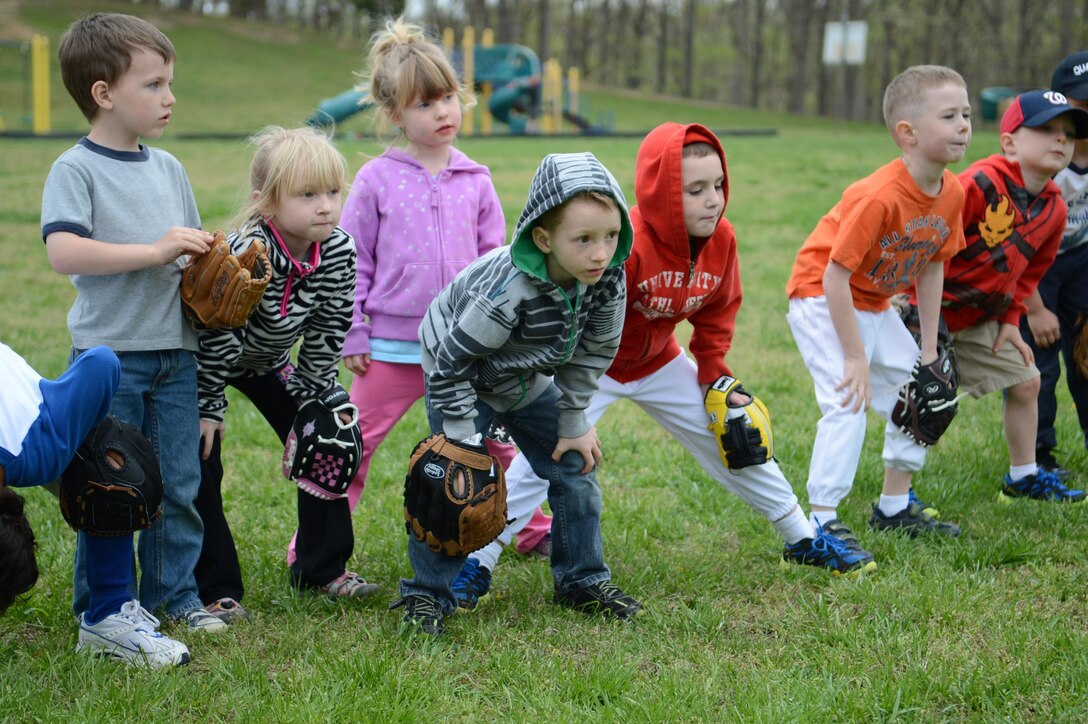 Children practice the proper technique for fielding a ground ball during a practice in front of W. W. Ashurst Elementary School aboard Marine Corps Base Quantico on April 15, 2013. The sport focuses on teaching teamwork as well as building and improving the athlete’s skills. 