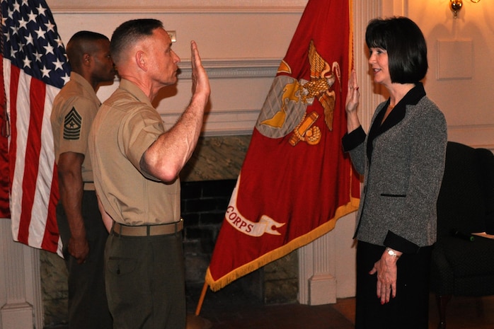 Brig. Gen. Frank Kelley, commander of Marine Corps Systems Command, gives Michelle Cresswell-Atkinson the Senior Executive Service oath during her SES induction ceremony April 18 in Harry Lee Hall at Marine Corps Base Quantico, Va. Cresswell-Atkinson serves as deputy commander for Resource Management and is the newest SES member at MCSC.