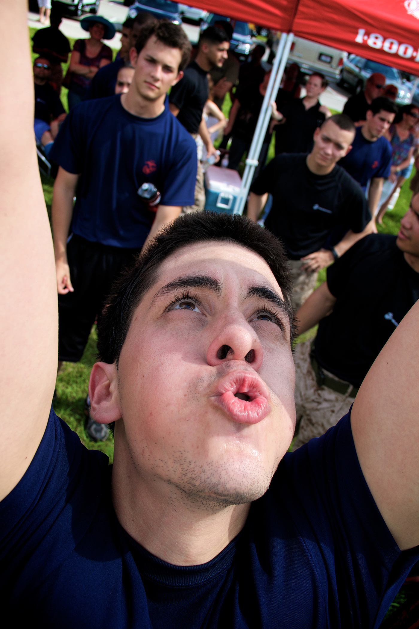 A future Marine with Recruiting Station Fort Lauderdale rests during the pull up completion at the annual field meet April 20, 2013. Hundreds of future Marines participated in various Marine Corps inspired competitions like squad pull ups, crunches and a knowledge test designed to give them a taste of boot camp.  