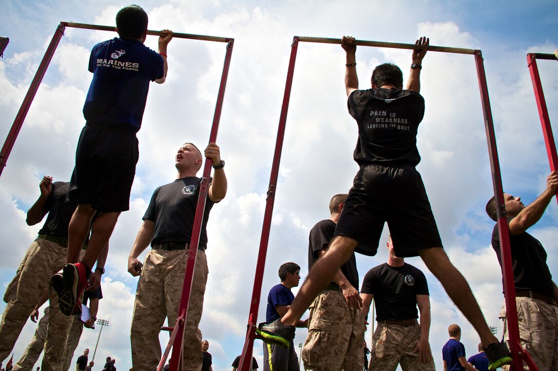 Sgt. Sean Smith, with Recruiting Substation Naples from Hudson Falls, N.Y., counts pull ups during Recruiting Station Fort Lauderdale’s annual future Marine field meet April 20, 2013. Hundreds of future Marines participated in various Marine Corps inspired competitions like squad pull ups, crunches and a knowledge test designed to give them a taste of boot camp.  