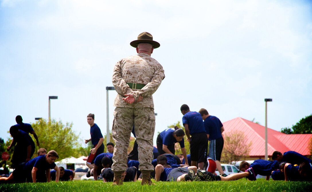 A drill instructor from Marine Corps Recruit Depot Parris Island, corrects a future Marine during Recruiting Station Fort Lauderdale’s annual field meet April 20, 2013. Hundreds of future Marines participated in various Marine Corps inspired competitions like squad pull ups, crunches and a knowledge test designed to give them a taste of boot camp.