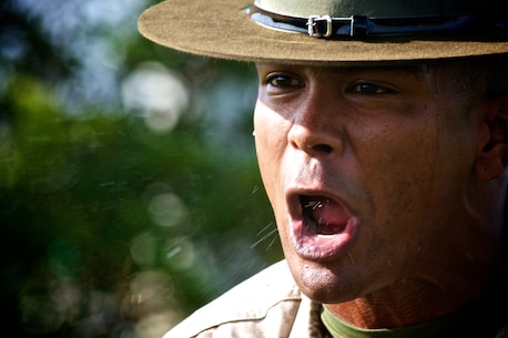 A drill instructor from Marine Corps Recruit Depot Parris Island, corrects a future Marine during Recruiting Station Fort Lauderdale’s annual field meet April 20, 2013. Hundreds of future Marines participated in various Marine Corps inspired competitions like squad pull ups, crunches and a knowledge test designed to give them a taste of boot camp.