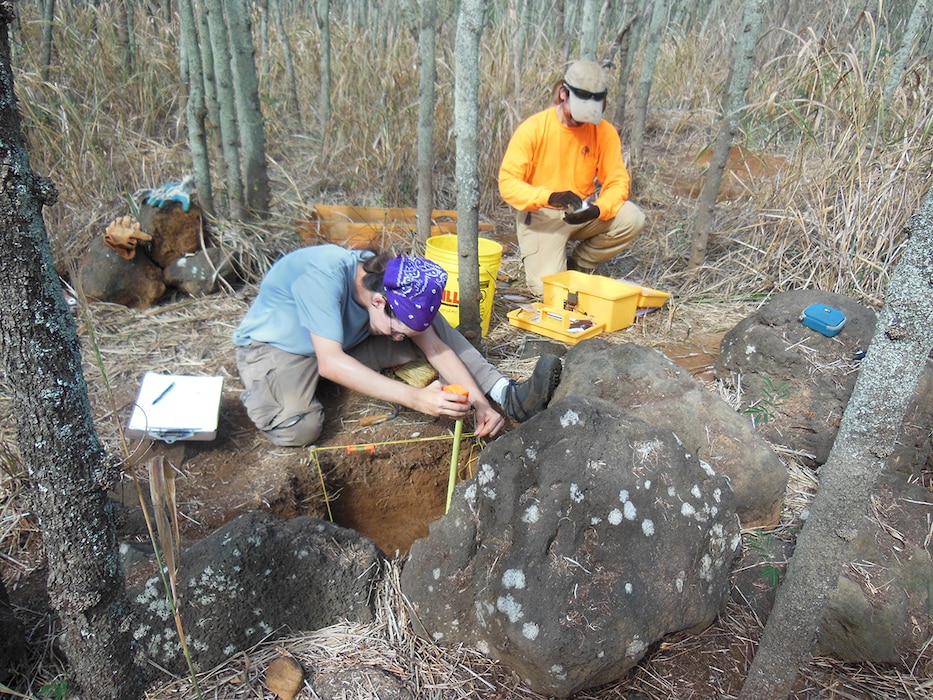 Archaeologists in the field carefully record the rock features that are the former house sites and agricultural fields of Hawaiians that once lived on Mokapu Peninsula.  
