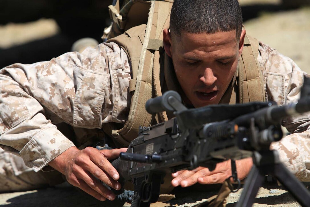 Staff Sgt. Courtney Hunt, a military policeman with 1st Law Enforcement Battalion, performs a function check on an M240B machine gun during a challenge course for the sixth event in the I Marine Expeditionary Force Commander's Cup tournament at Camp Pendleton, Calif., April 18. The Commander's Cup consists of seven challenges over the course of seven months. The final challenge will take place next month, where the winning battalion will be announced. Hunt, 31, is from Hoke County, N.C.