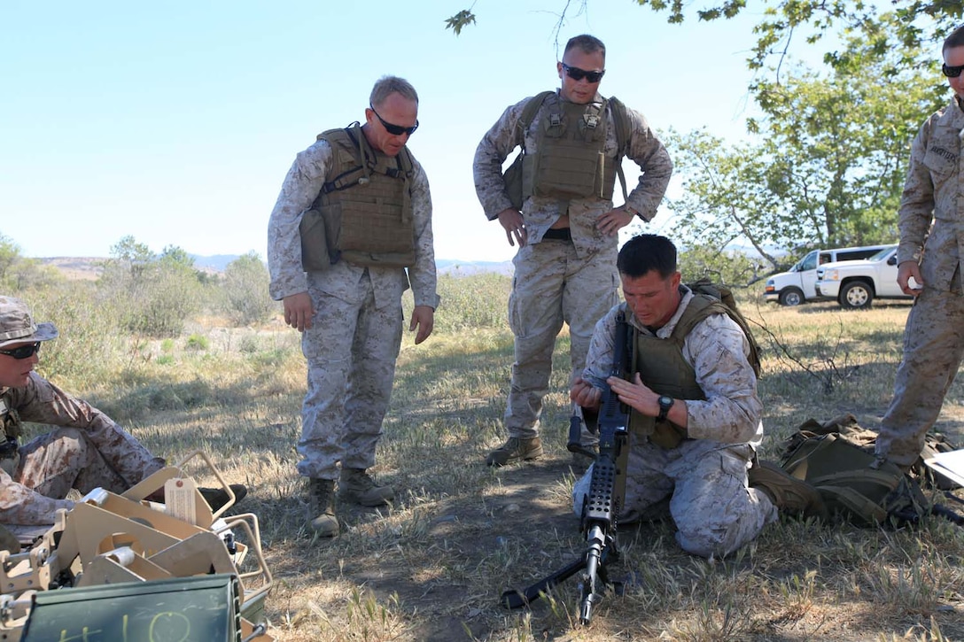 Staff Sgt. Jasan Thomason, the operations chief for 1st Intelligence Battalion, performs a function check on an M240B machine gun during a challenge course for the sixth event in the I Marine Expeditionary Force Commander's Cup tournament at Camp Pendleton, Calif., April 18. The Commander's Cup consists of seven challenges over the course of seven months. The final challenge will take place next month, where the winning battalion will be announced. Thomason, 28, is from Walla Walla, Wash.
