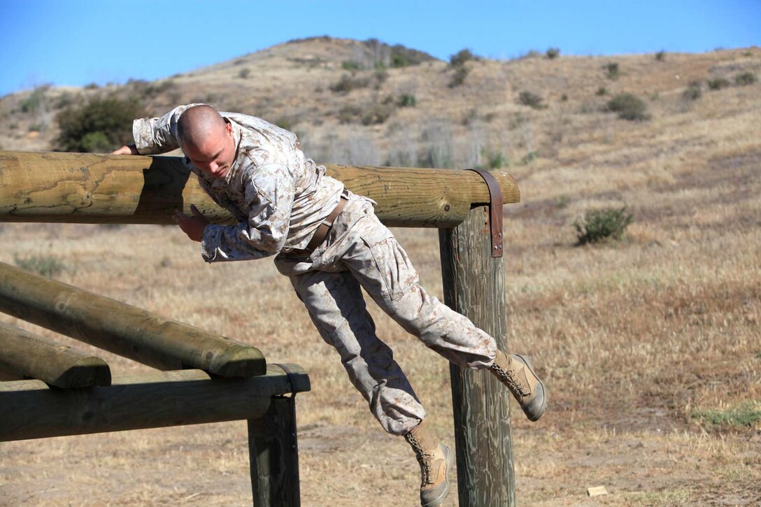 Cpl. Jesse Swayze, a military policeman with 1st Law Enforcement Battalion, jumps over an obstacle during the I Marine Expeditionary Force Commander's Cup tournament at Camp Pendleton, Calif., April 18. The Commander's Cup consists of seven challenges over the course of seven months. The final challenge will take place next month, where the winning battalion will be announced.