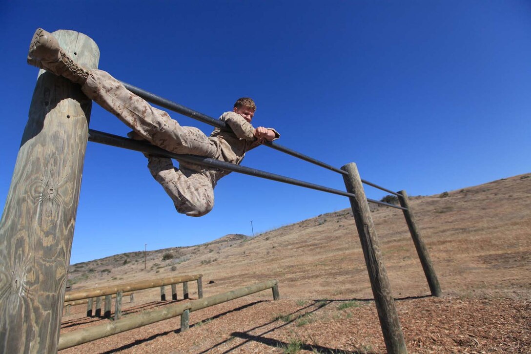 Lance Cpl. Austin Anderson, a motor transportation mechanic with 1st Radio Battalion, climbs an obstacle during the I Marine Expeditionary Force Commander's Cup tournament at Camp Pendleton, Calif., April 18. The Commander's Cup consists of seven challenges over the course of seven months. The final challenge will take place next month, where the winning battalion will be announced. Anderson, 20, is from West Bountiful, Utah.