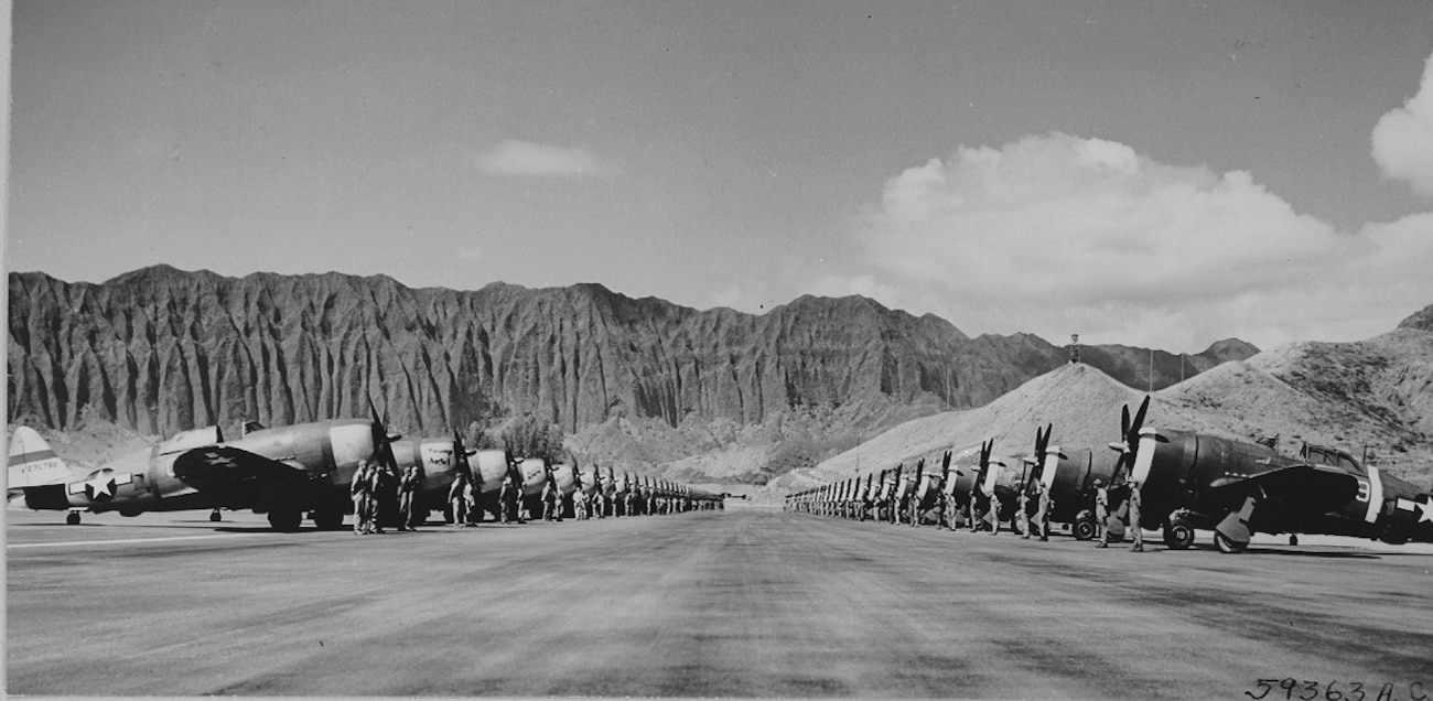 Republic P-47 Thunderbolts lined up for inspection at Bellows Field (now Marine Corps Training Area Bellows) during World War II. The P-47 was the largest fighter aircraft powered by a single-piston engine.  It was heavily armed with eight .50-caliber machine guns and up to 2,500 lbs of Bombs. 