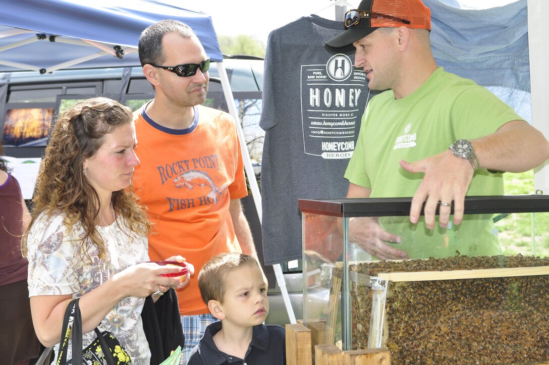 Capt. Justin Strickler describes how bees make honey during the 2013 Earth Day on the Rappahonnock at Old Mills Park in Fredricksburg on April 13, 2013. Strickler and Chief Warrant Officer James McWilliams started Honeycomb Heroes, a honey making business, as a hobby in 2011. After attending a SCORE class on how to start your own business at the Chapel Annex on Marine Corps Base Quantico, they decided to get serious about making honey. Within three years of buying their first bee hive, they expect to be in the black this year.