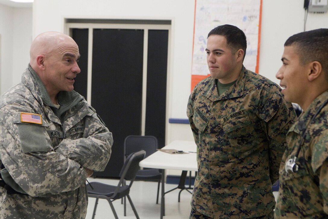 Maj. Gen. Thomas Katkus, adjutant general for the Alaska Department of Military and Veterans Affairs, talks with Lance Cpl. Moises Zepedaserrano of 4th Medical Battalion, 4th Marine Logistics Group, Marine Forces Reserve, and Navy Petty Officer 2nd Class David Pereira, hospital man, 4th Dental Bn., 4th MLG, MARFORRES, at the Noorvik School, April 20.  Katkus was one the distinguished visitors who traveled to three of the 12 Alaskan villages taking part in Innovative Readiness Training Arctic Care 2013. The exercise is a multi-service humanitarian and training program that focuses on enhancing the capability of U.S. forces in peacetime support operations, humanitarian assistance and disaster relief. IRT Arctic Care brings medical, dental and veterinary aid to 12 rural villages in Alaska. The exercise is primarily a Reserve effort with Marine Forces Reserve taking the lead and receiving logistical and medical support from the National Guard, Army Reserve, Navy Reserve and Air Force Reserve.