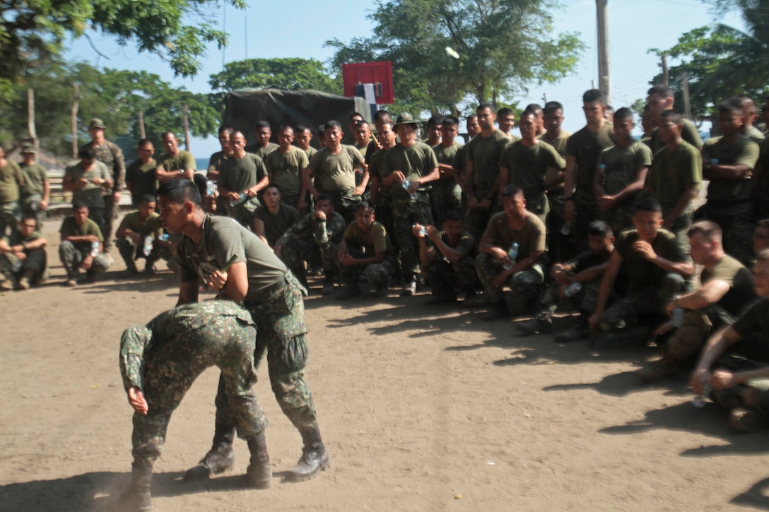 Philippine Marine Corps Martial Arts master instructor Sgt. Eddy Mendoza demonstrates takedown techniques to the U.S. Marines and sailors with Company B., Battalion Landing Team 1st Battalion, 5th Marines, 31st Marine Expeditionary Unit, as a part of exercise Balikatan 2013 in Ternate, Philippines, April 10. As treaty allies, the Armed Forces of the Philippines and U.S. military have a longstanding relationship that has contributed to regional security and stability. The 31st MEU is the only continuously forward-deployed MEU and is the Marine Corps’ force in readiness in the Asia-Pacific region.