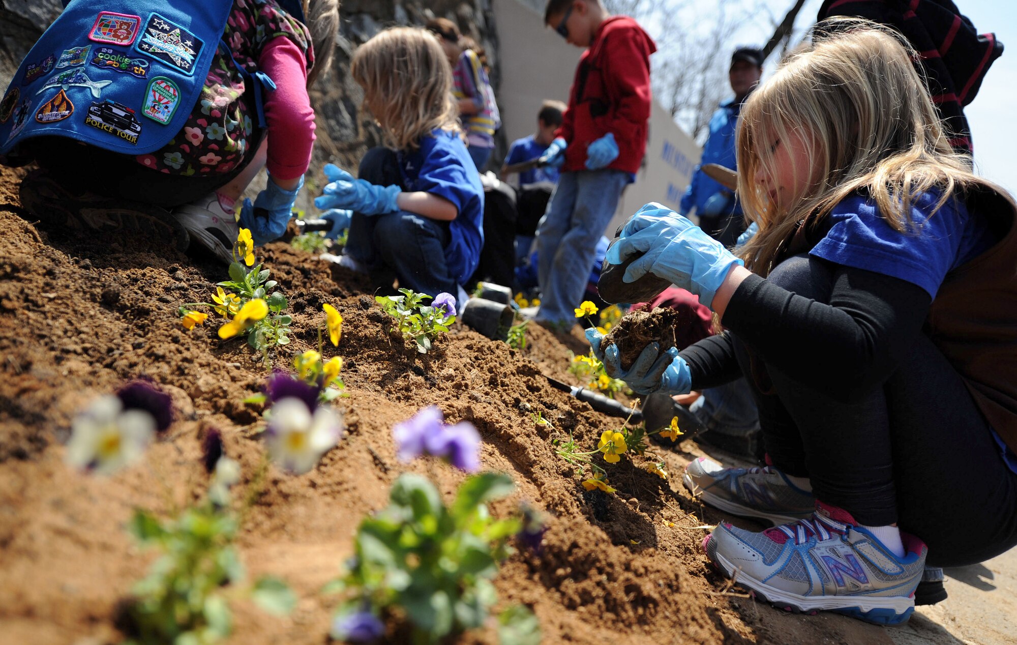 Students from Osan Elementary School plant flowers to help celebrate Earth Day at Osan Air Base, Republic of Korea, April 19, 2013. Students from the Osan American schools and Osan community members helped raise awareness for Earth Day by participating in poster contests, planting trees and pledging to help better the Earth. (U.S. Air Force photo/ Staff Sgt. Sara Csurilla) 