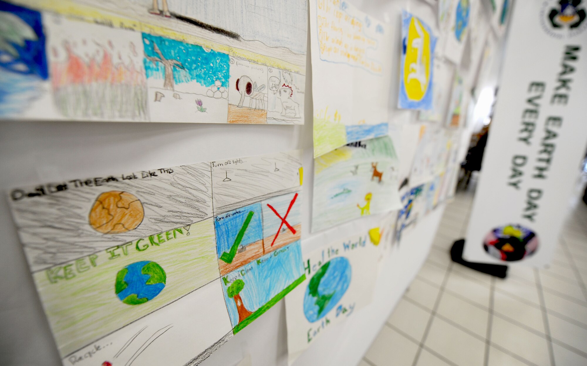 Hand-drawn posters submitted by students from Osan’s American Schools hang on a wall inside Osan’s Base Exchange at Osan Air Base, Republic of Korea, April 22, 2013. The poster contest’s theme was climate change and was held to remind people to take better care of the Earth. (U.S. Air Force photo/ Staff Sgt. Sara Csurilla)