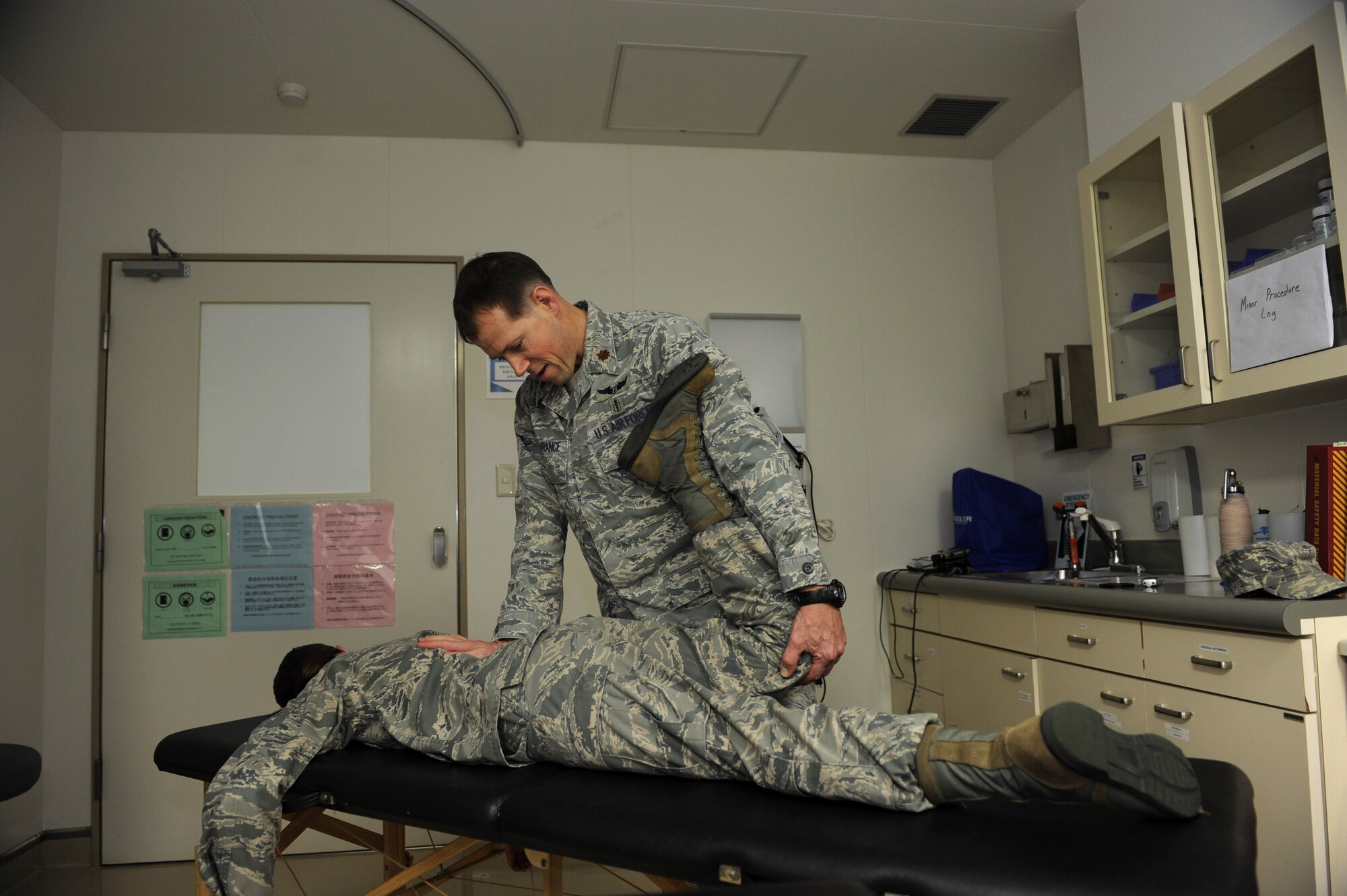U.S. Air Force Maj. Arthur Lawrance, 353rd Special Operations Support Squadron flight surgeon, performs osteopathic manipulation on a patient at the 18th Medical Group on Kadena Air Base, Japan, April 10, 2013. Lawrance begins with this type of therapy before an acupuncture treatment in order to find physical issues in patients before their procedure. (U.S. Air Force photo by Airman 1st Class Hailey R. Davis/Released)