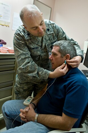 Lt. Col. (Dr.) Paul Crawford, 99th Medical Operations Squadron associate program director for Nellis Family Medicine Residency, attaches an Alpha Simulator to U.S Army Staff Sgt. Paul Kelly, motor transport operator from the Community Base Warrior Transition Unit in Fort Lewis, Wash., during his acupuncture appointment April 17, 2013, at the Mike O’Callaghan Federal Medical Center, at Nellis Air Force Base, Nev. An Alpha Stimulator is used for electro-acupuncture. Electro-acupuncture is a form of acupuncture where a small electric current is passed between pairs of acupuncture needles. This practice augments the use of regular acupuncture, can restore health and well-being, and is particularly good for treating pain. (U.S. Air Force photo by Senior Airman Matthew Lancaster)