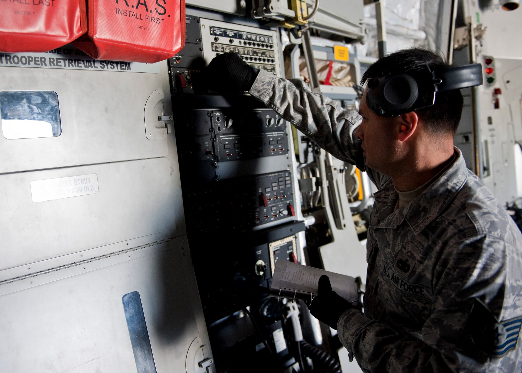 YOKOTA AIR BASE, Japan -- Tech. Sgt. Francisco Venega, 730th Ramp Service NCO in charge, inspects a C-17 Globemaster III at Yokota Air Base, Japan, April 22, 2013.  A group from Ramp Service does pre-flight inspections which save a lot of time and money while crew is on crew rest. (U.S. Air Force photo by Airman 1st Class Meagan Schutter/Released)