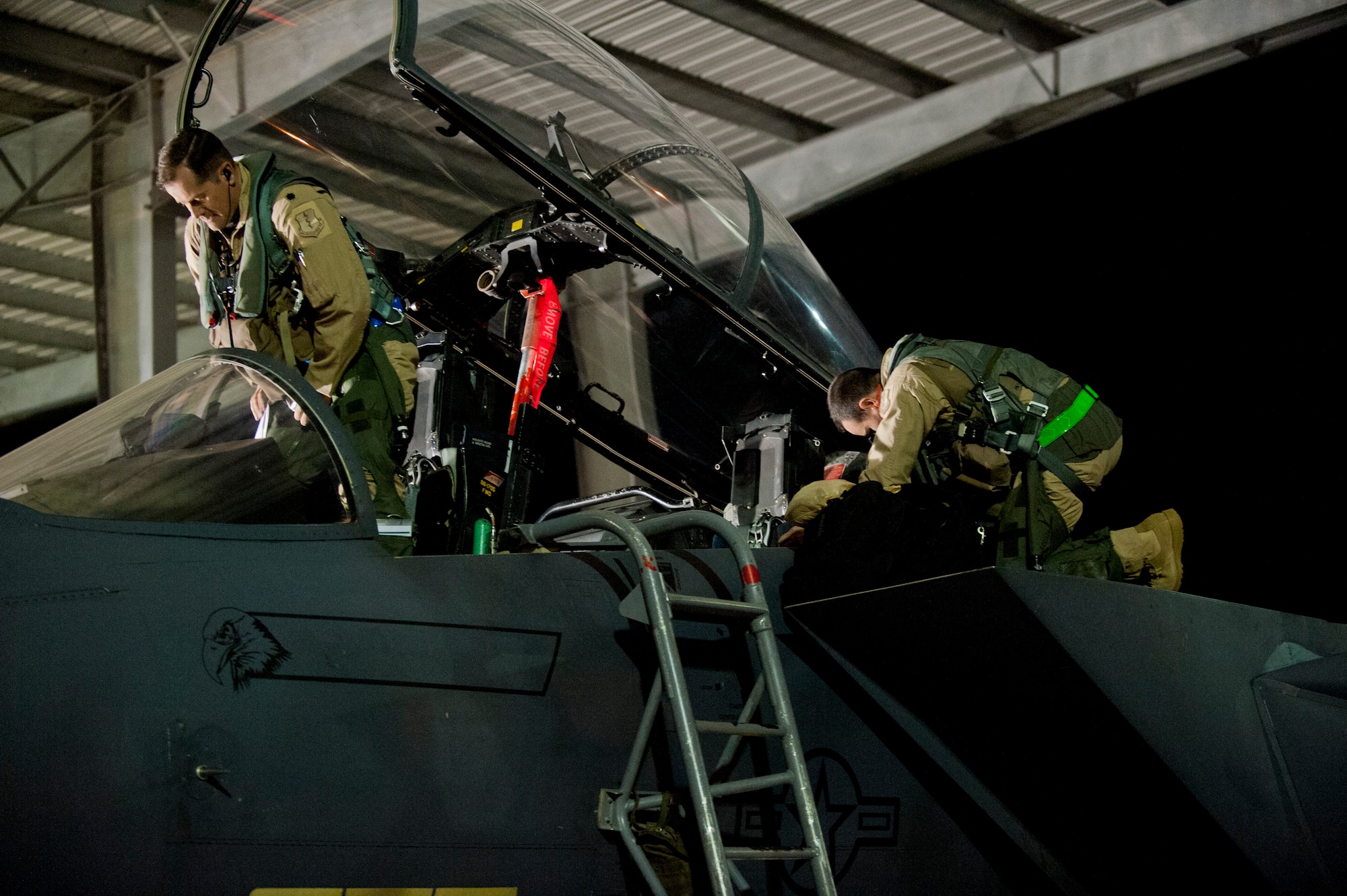 U.S. Air Force Lt. Col. Aaron Meyers, 389th Fighter Squadron commander, and Capt. Craig Sanders, 389th FS chief of mission planning, perform preflight checks in an F-15E Strike Eagle at Mountain Home Air Force Base, Idaho, April 21, 2013. Members from the 389th FS and Aircraft Maintenance Unit deployed to Southwest Asia to conduct combat operations and meet combatant commander requirements. (U.S. Air Force photo/Staff Sgt. Roy Lynch) (Released)