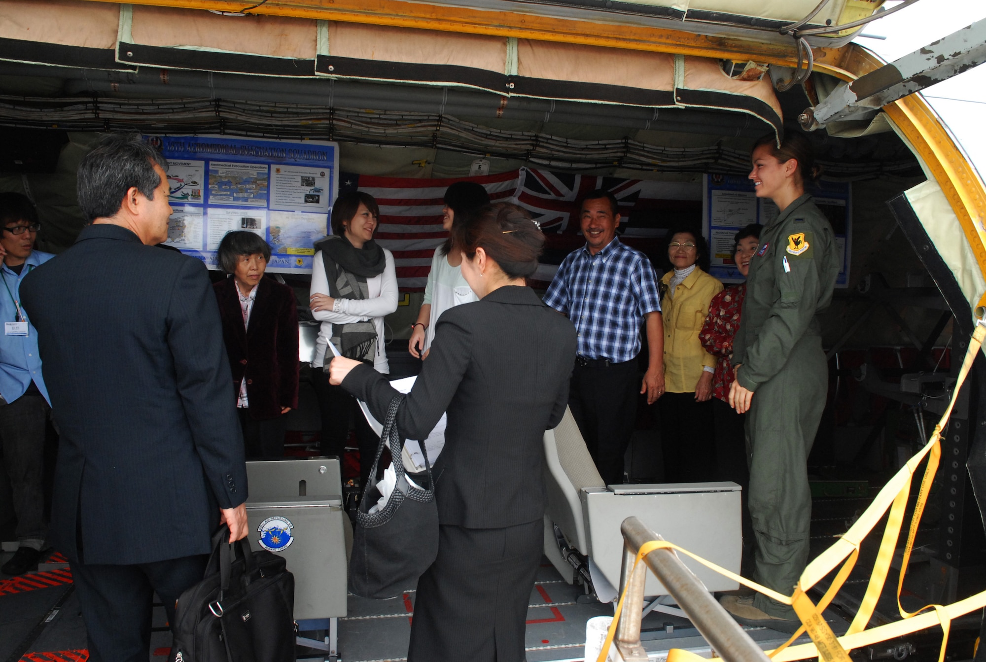 U.S. Air Force 1st Lt. Katherine Slugocki, 18th Aeromedical Evacuation Squadron pilot, briefed clergy on her squadron's mission in transporting and caring for American patients across the Pacific area of responsibility during the Japanese Clergy Day on Kadena Air Base, Japan, April 19, 2013. Participants had the chance to tour the 33rd Rescue Squadron's HH-60 Pave Hawk helicopter, the 44th Fighter Squadron's F-15 Eagle fighter aircraft, and the 909th Air Refueling Squadron's KC-135 Stratotanker refueling aircraft. (U.S. Air Force photo by Staff Sgt. Lauren Snyder/Released)