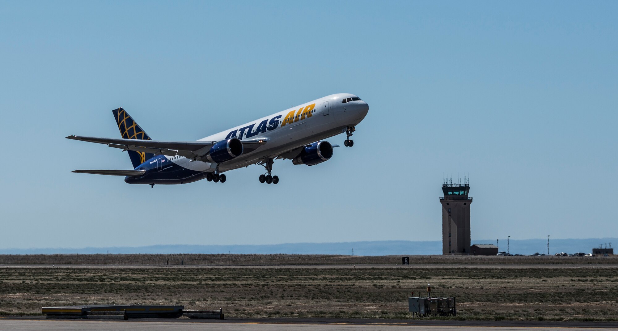 An aircraft carrying deploying Airmen takes off from Mountain Home Air Force Base, Idaho, April 23, 2013. The Airmen will support Operation Enduring Freedom from a base in Southwest Asia. (U.S. Air Force photo/Tech. Sgt. Samuel Morse)