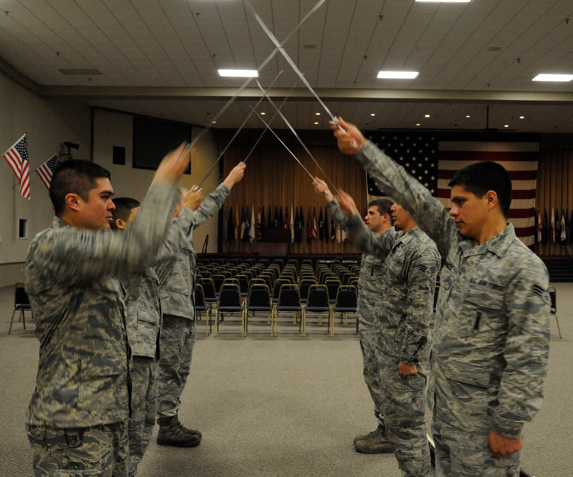 Airmen assigned to the Barksdale Honor Guard Bravo flight practice the saber cordon on Barksdale Air Force Base, La., April 23, 2013. Airmen walk under a saber cordon during promotion ceremonies to signify the transition of junior Airmen entering the NCO ranks and NCOs entering the senior NCO ranks. It is also used to recognize winners and nominees for awards. (U.S. Air Force photo/Airman 1st Class Andrew Moua)