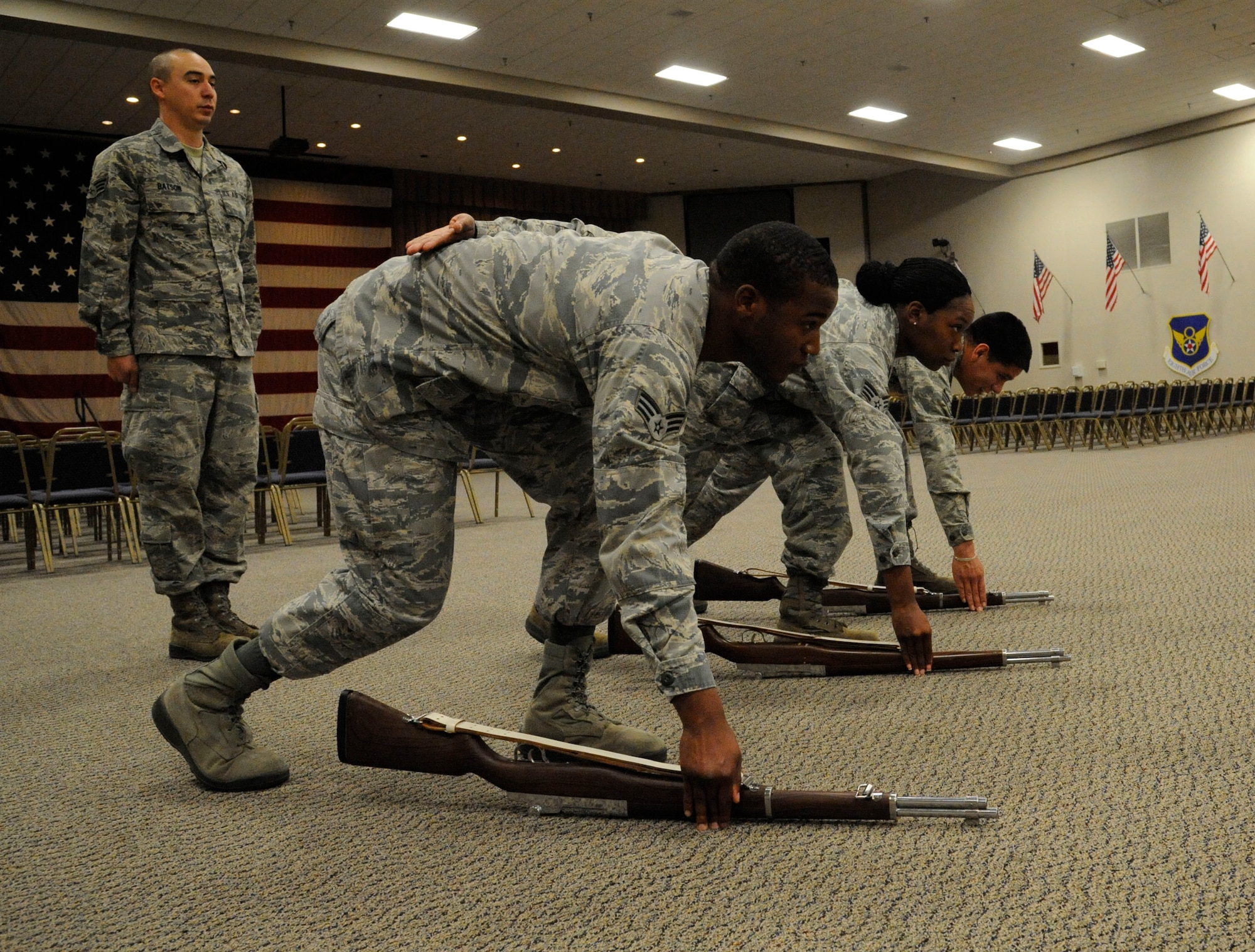 Airmen from the Honor Guard Bravo flight stand at ready arms while practicing a three-volley salute on Barksdale Air Force Base, La., April 23, 2013. A tradition which dates back to the European dynastic wars, where fighting ceased to collect the dead, and three shots were fired which signaled the battle could resume. (U.S. Air Force photo/Airman 1st Class Andrew Moua)