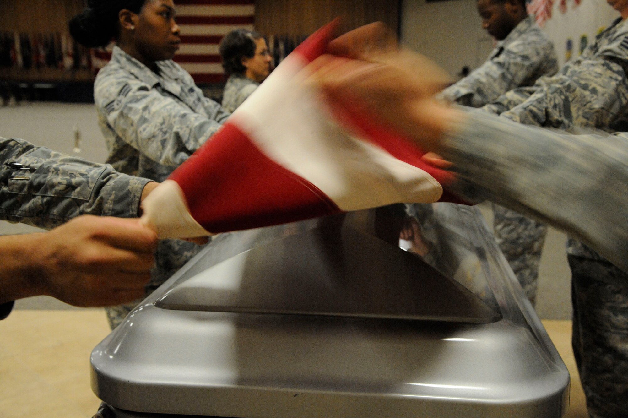 Airmen from the Barksdale Honor Guard Bravo flight fold the American flag during training on Barksdale Air Force Base, La., April 23, 2013. Honor Guard Airmen perform a variety of ceremonies to honor veterans and retirees such as retirement ceremonies, promotion ceremonies, service as pall-bearers and public events. (U.S. Air Force photo/Airman 1st Class Andrew Moua)